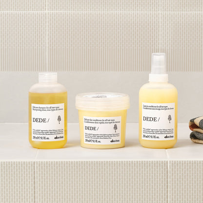 Davines DEDE Leave-In Conditioner shown in a styled bathroom setting