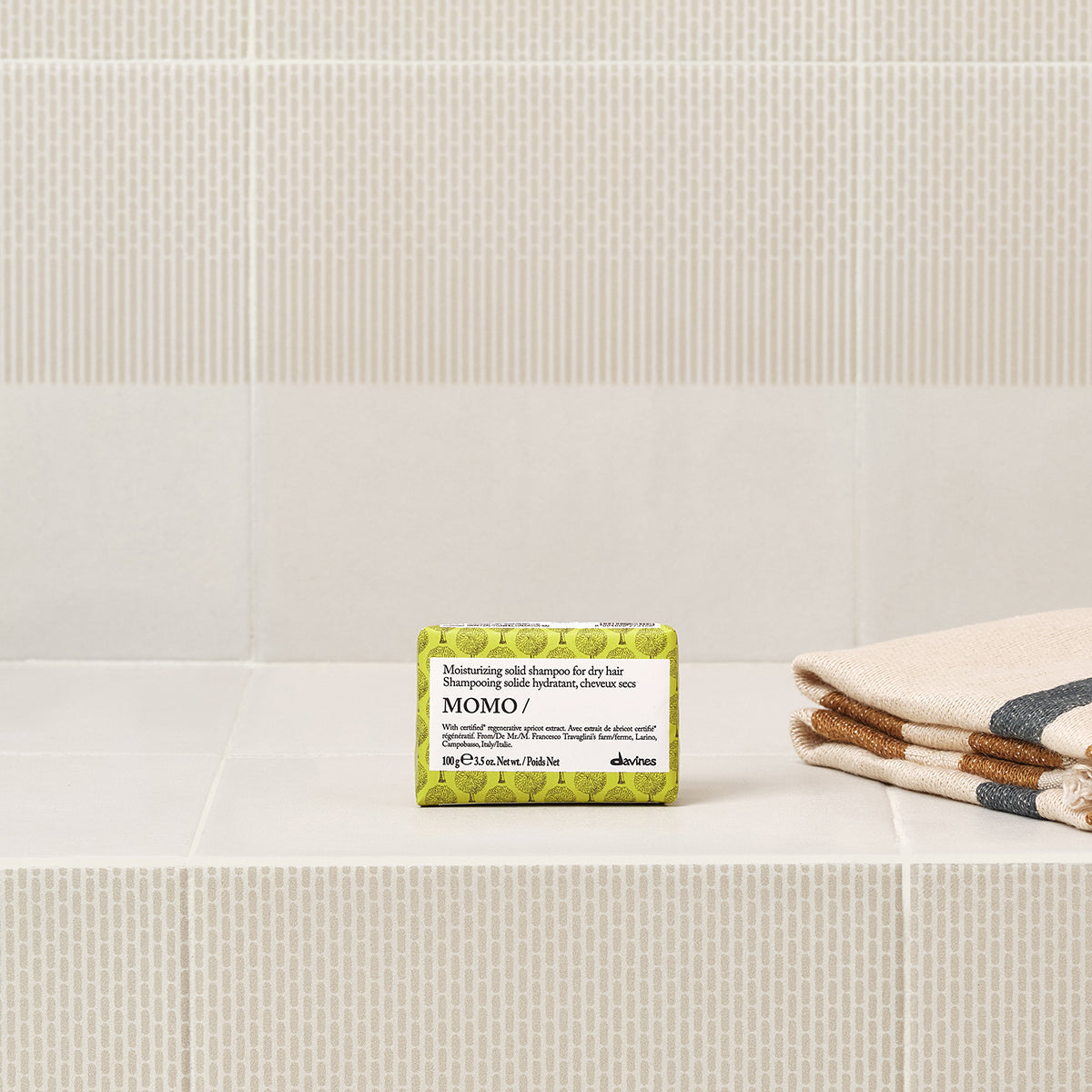 Davines Momo Solid Shampoo bar shown in a styled bathroom setting